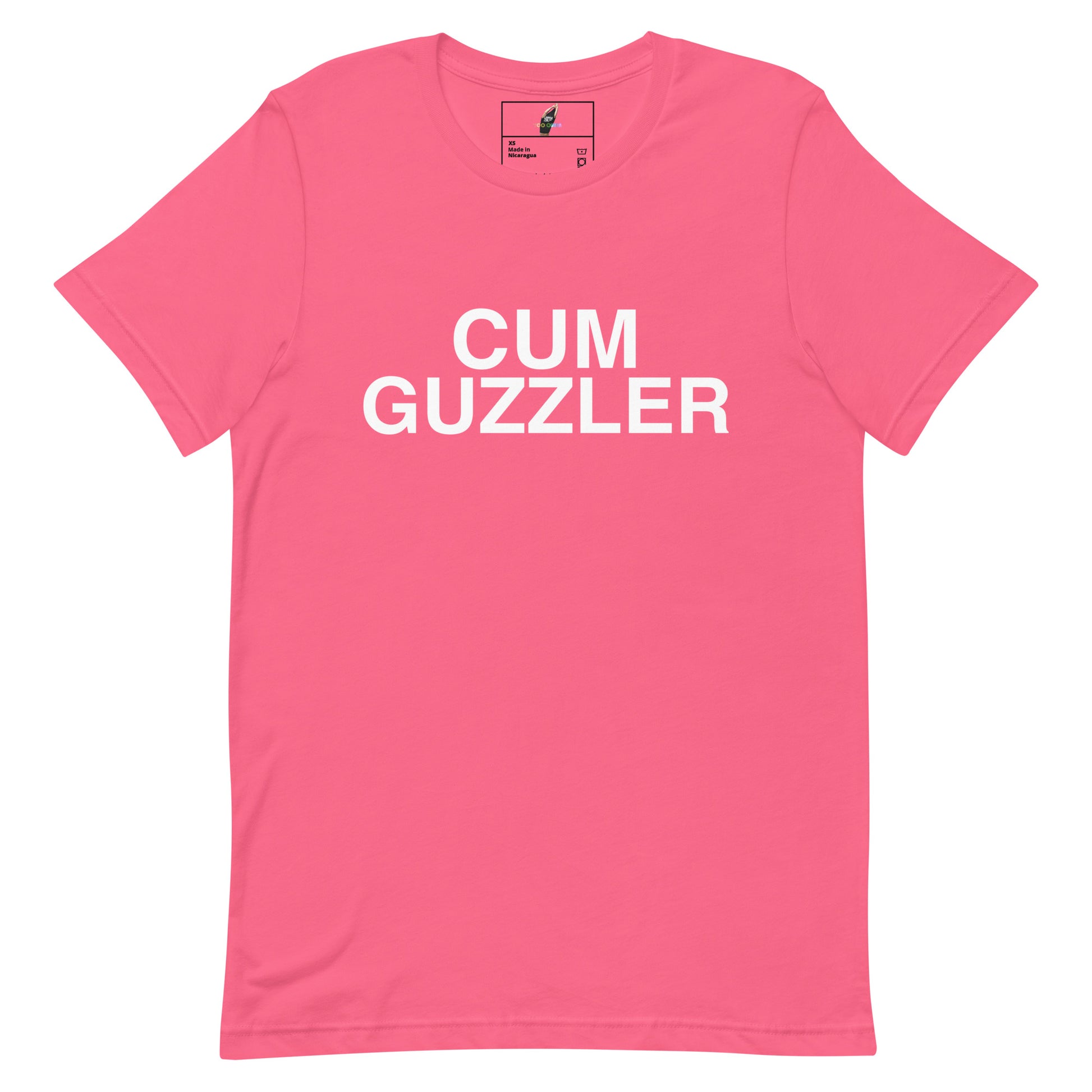 A bright pink short-sleeve t-shirt with the words 'CUM GUZZLER' printed in bold white capital letters across the chest, displayed flat against a plain white background.