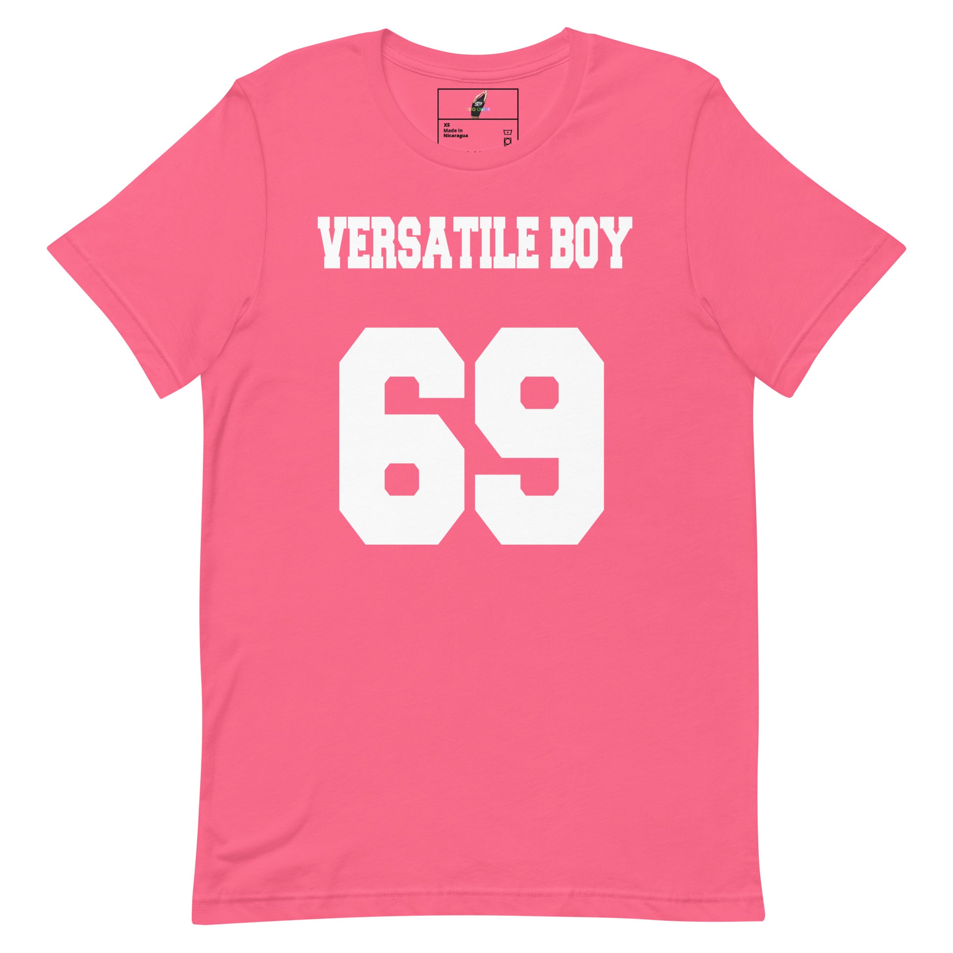 A pink short-sleeve t-shirt with 'VERSATILE BOY' and the number '69' printed in bold white block letters on the front, displayed against a solid white background.