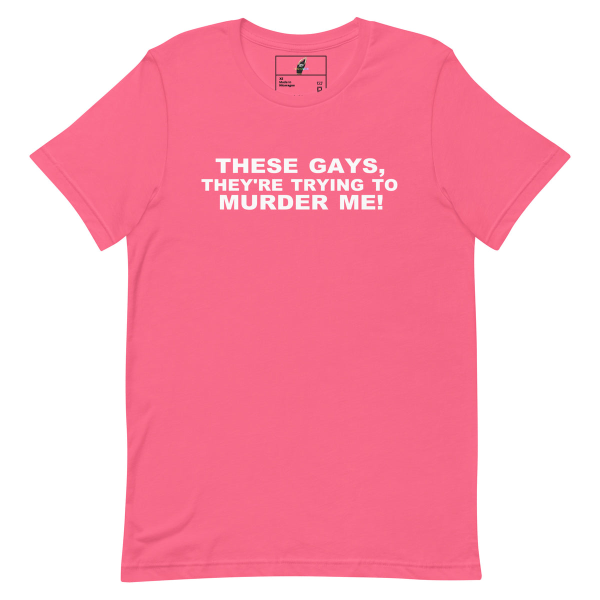 A bright pink short-sleeve crewneck t-shirt with bold white text on the chest reading 'THESE GAYS, THEY'RE TRYING TO MURDER ME!'. The shirt is displayed flat against a clean white background.