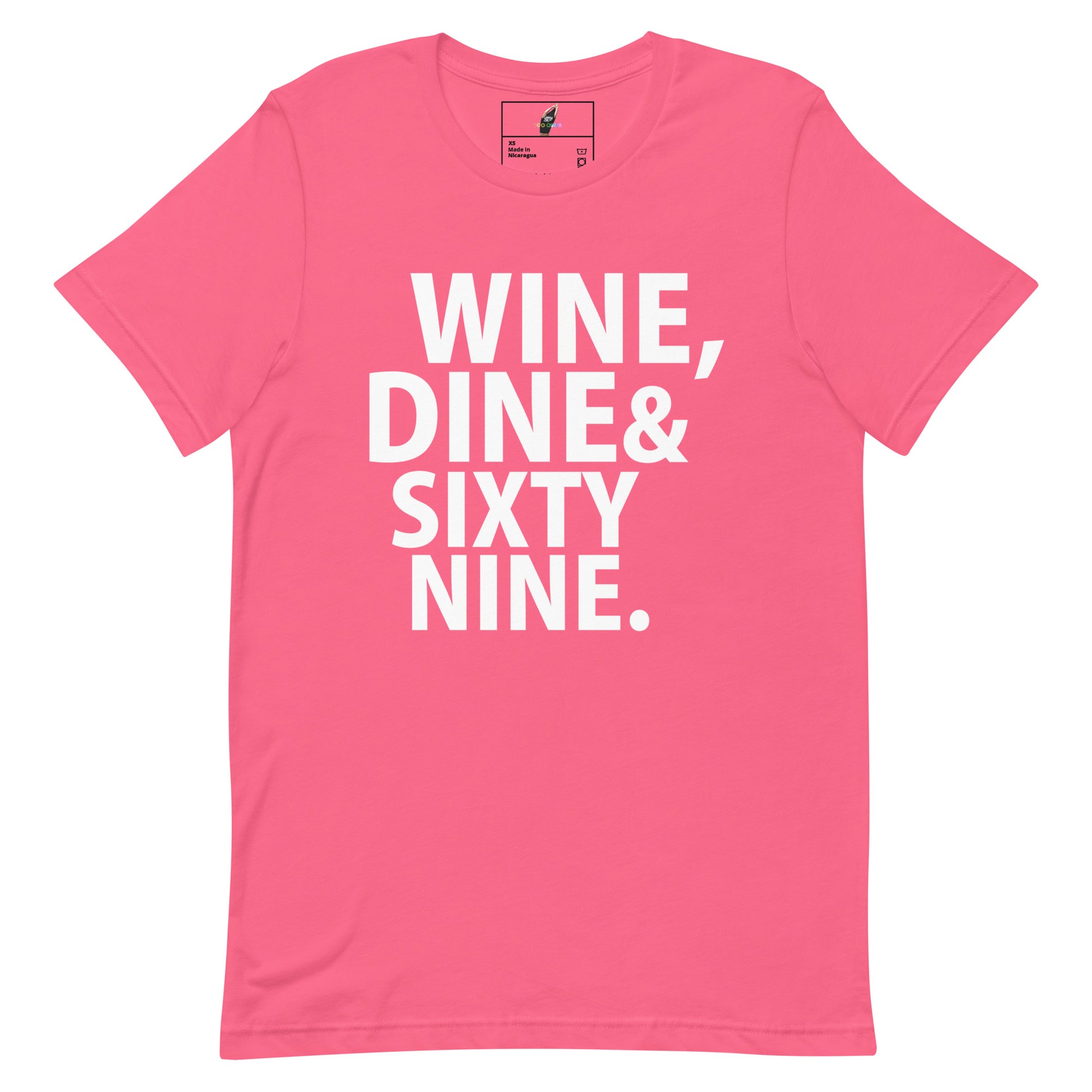 A bright pink short-sleeve t-shirt with bold white text on the front reading 'WINE, DINE & SIXTY NINE.' on a plain white background.