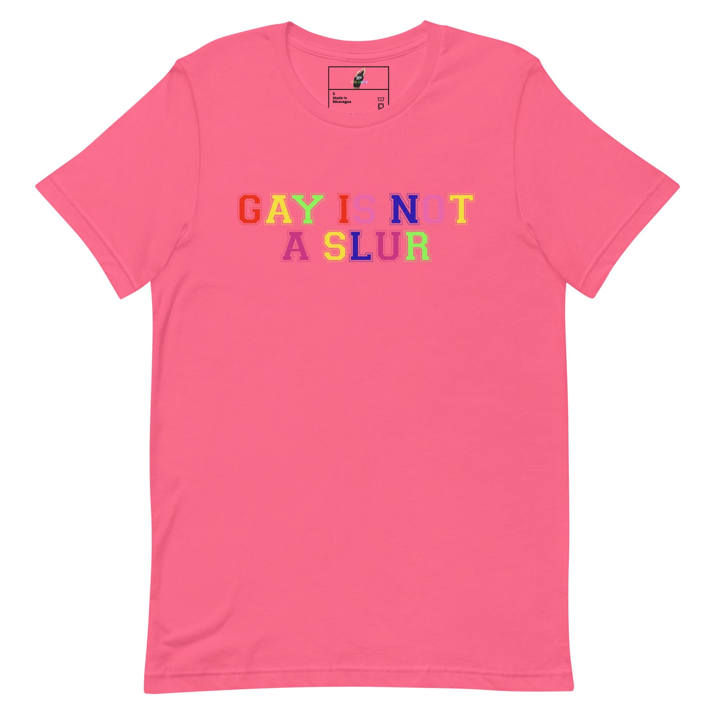 A pink short-sleeve crewneck t-shirt featuring the text 'GAY IS NOT A SLUR' printed across the chest in a rainbow-colored bubble font.