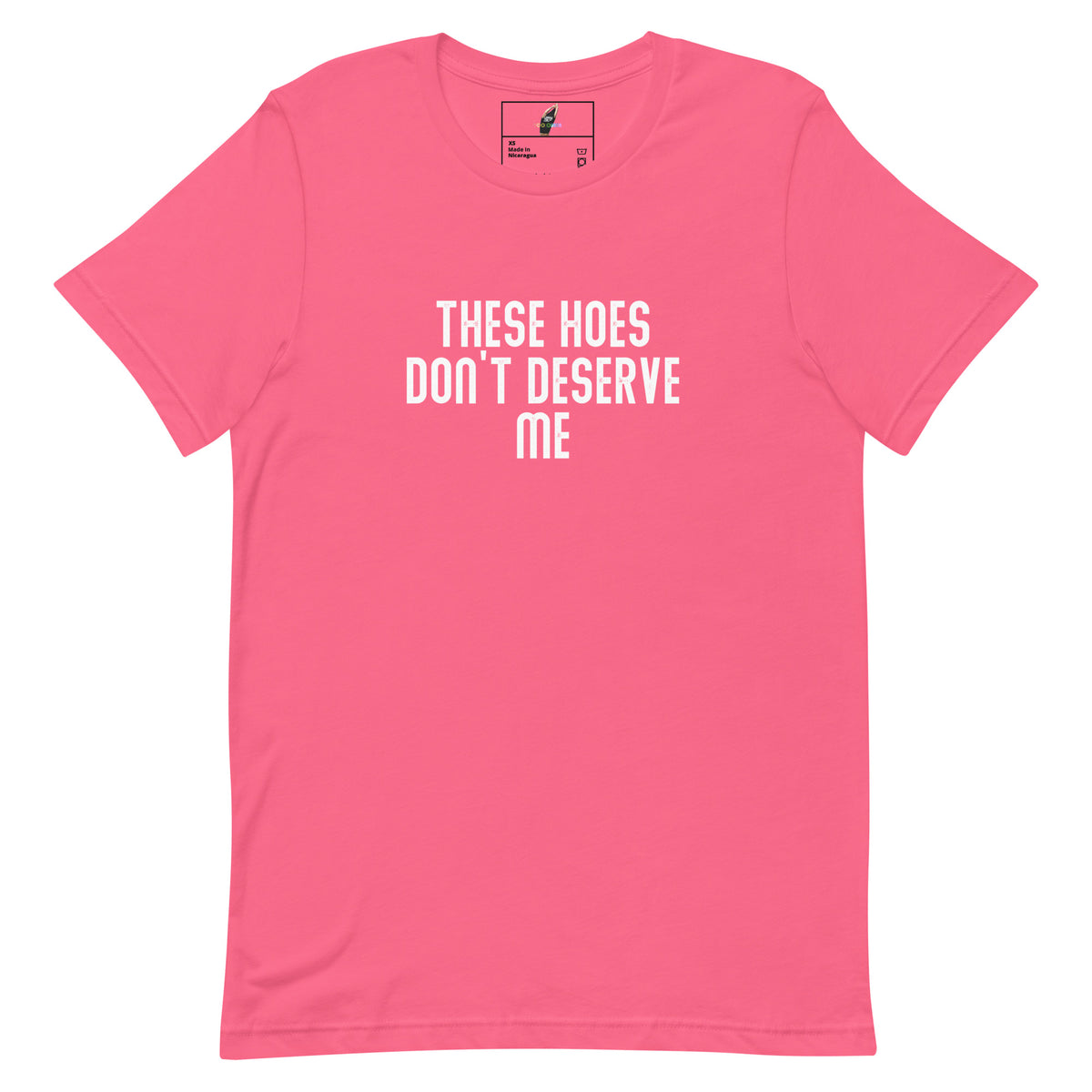 A pink short-sleeve crewneck t-shirt with the text 'THESE HOES DON'T DESERVE ME' printed in white capital letters on the chest, displayed flat against a white background.