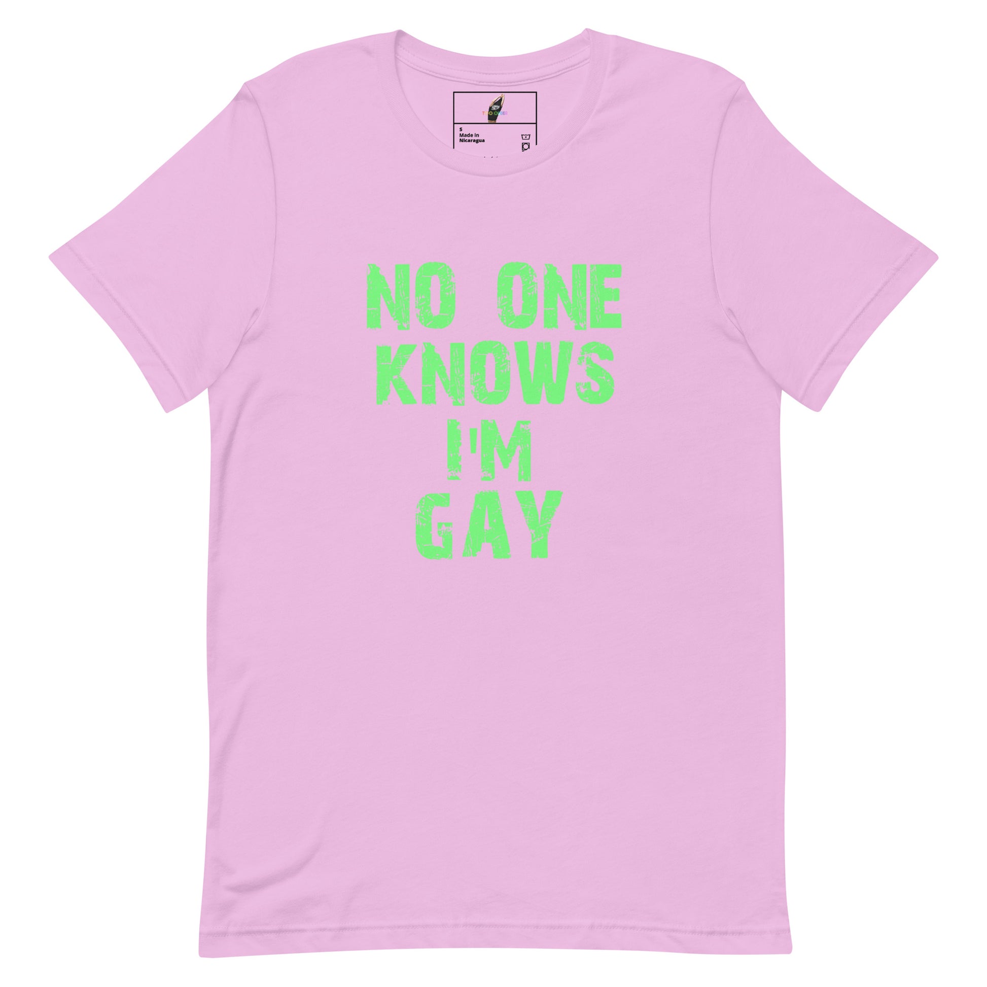 A light pink short-sleeve t-shirt with the phrase 'NO ONE KNOWS I'M GAY' printed in a distressed neon green font on the front, displayed flat against a white background.