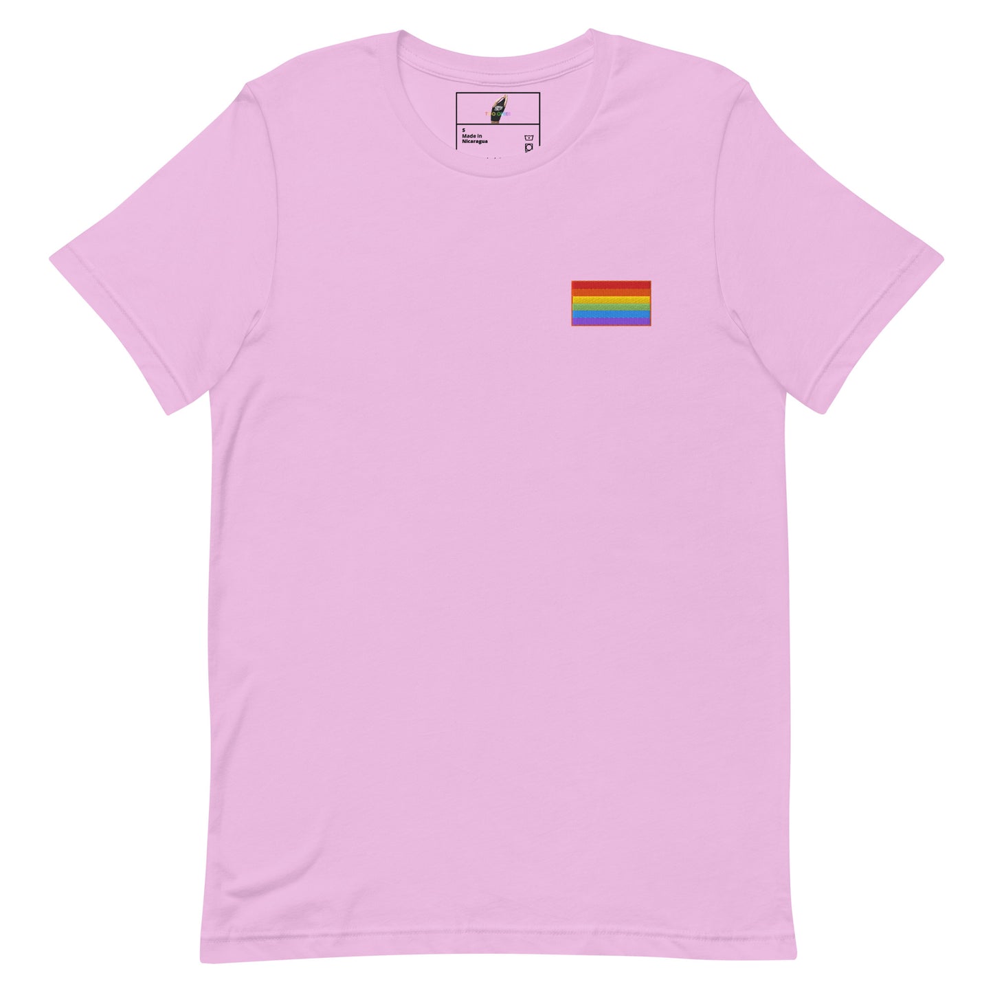 A light pink short-sleeve crewneck t-shirt with a small rainbow pride flag graphic printed on the left chest, displayed on a clean white background.