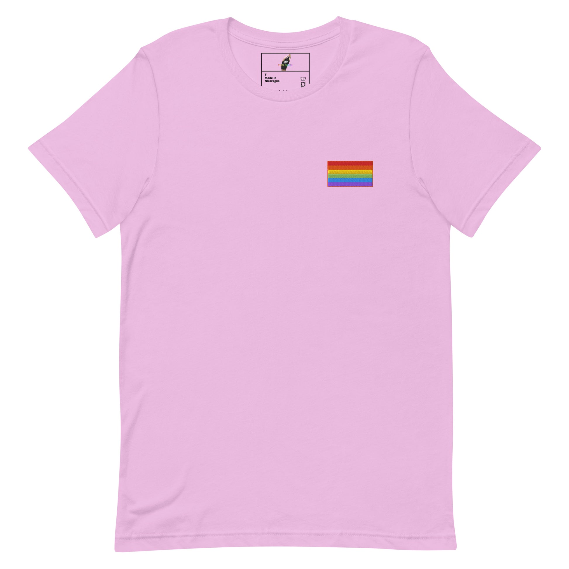 A light pink short-sleeve crewneck t-shirt with a small rainbow pride flag graphic printed on the left chest, displayed on a clean white background.