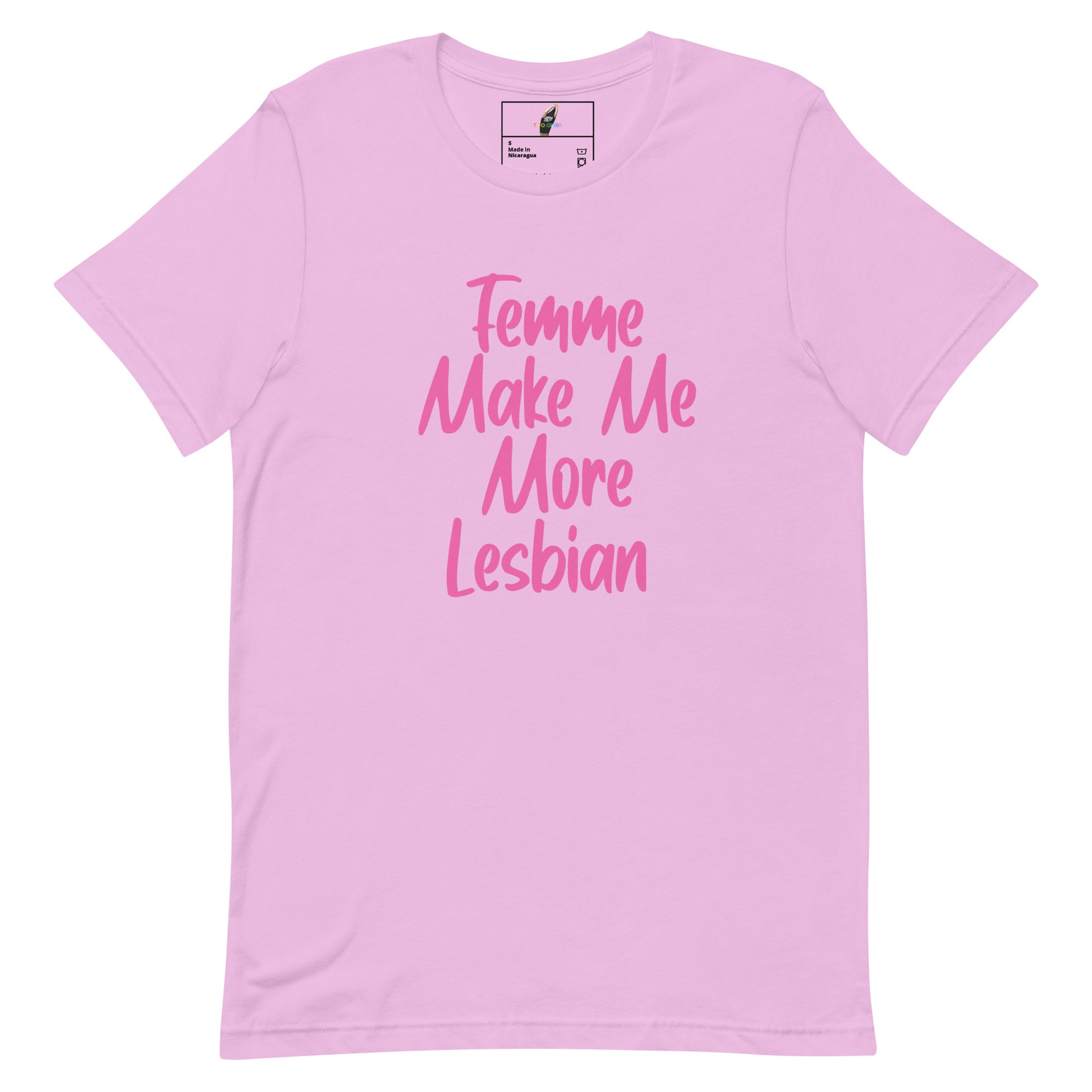 A light pink short-sleeve t-shirt with the phrase 'Femme Make Me More Lesbian' printed in a darker pink script font on the front, displayed against a solid white background.