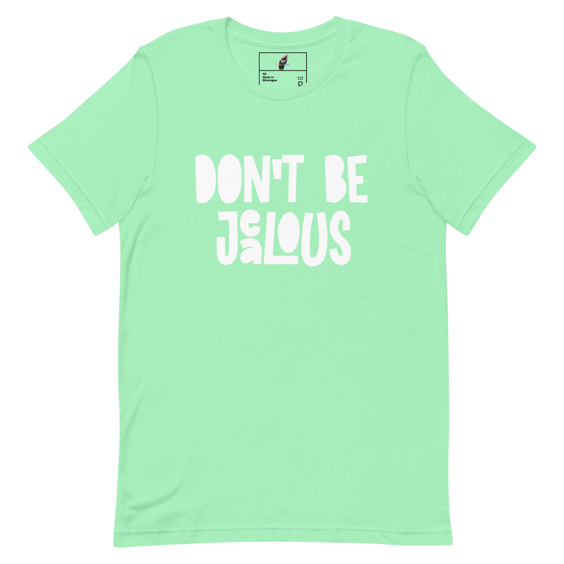 A mint green short-sleeve t-shirt with the phrase 'DON'T BE JALOUS' printed in a bold, white, hand-drawn style font across the chest. The shirt is displayed flat against a solid white background, with a small brand label visible inside the collar.