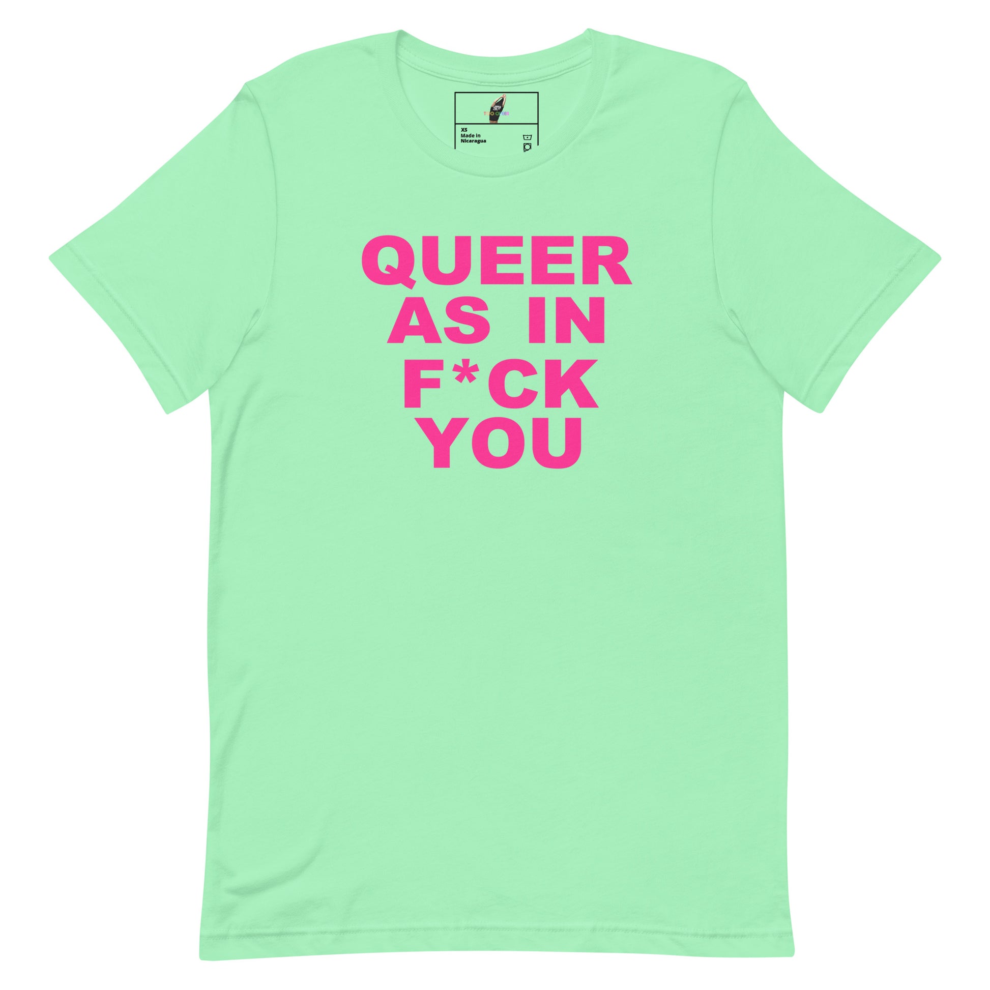A mint green short-sleeve t-shirt with bold pink text on the front reading 'QUEER AS IN F*CK YOU'. The shirt is displayed flat against a solid white background, with a small brand label visible inside the collar.