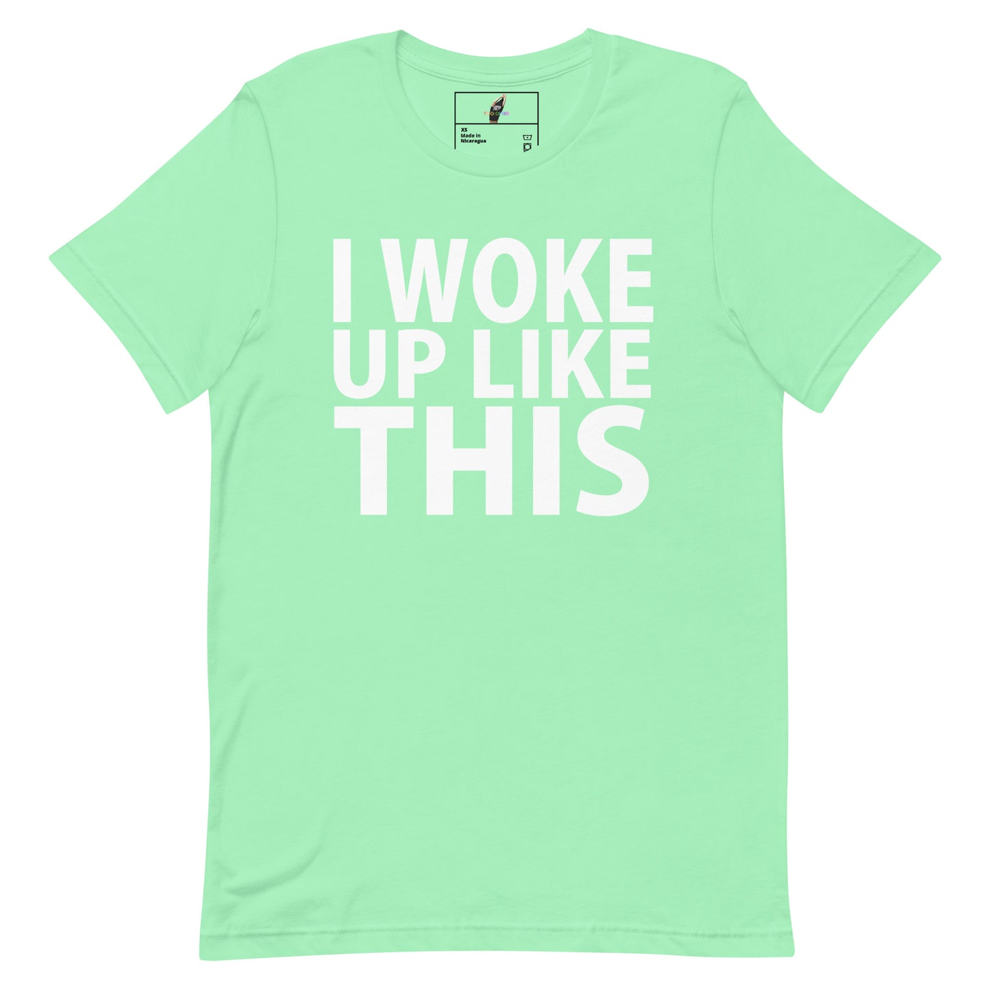 A mint green short-sleeve t-shirt with the phrase 'I WOKE UP LIKE THIS' printed in bold white capital letters across the front, displayed on a clean white background.