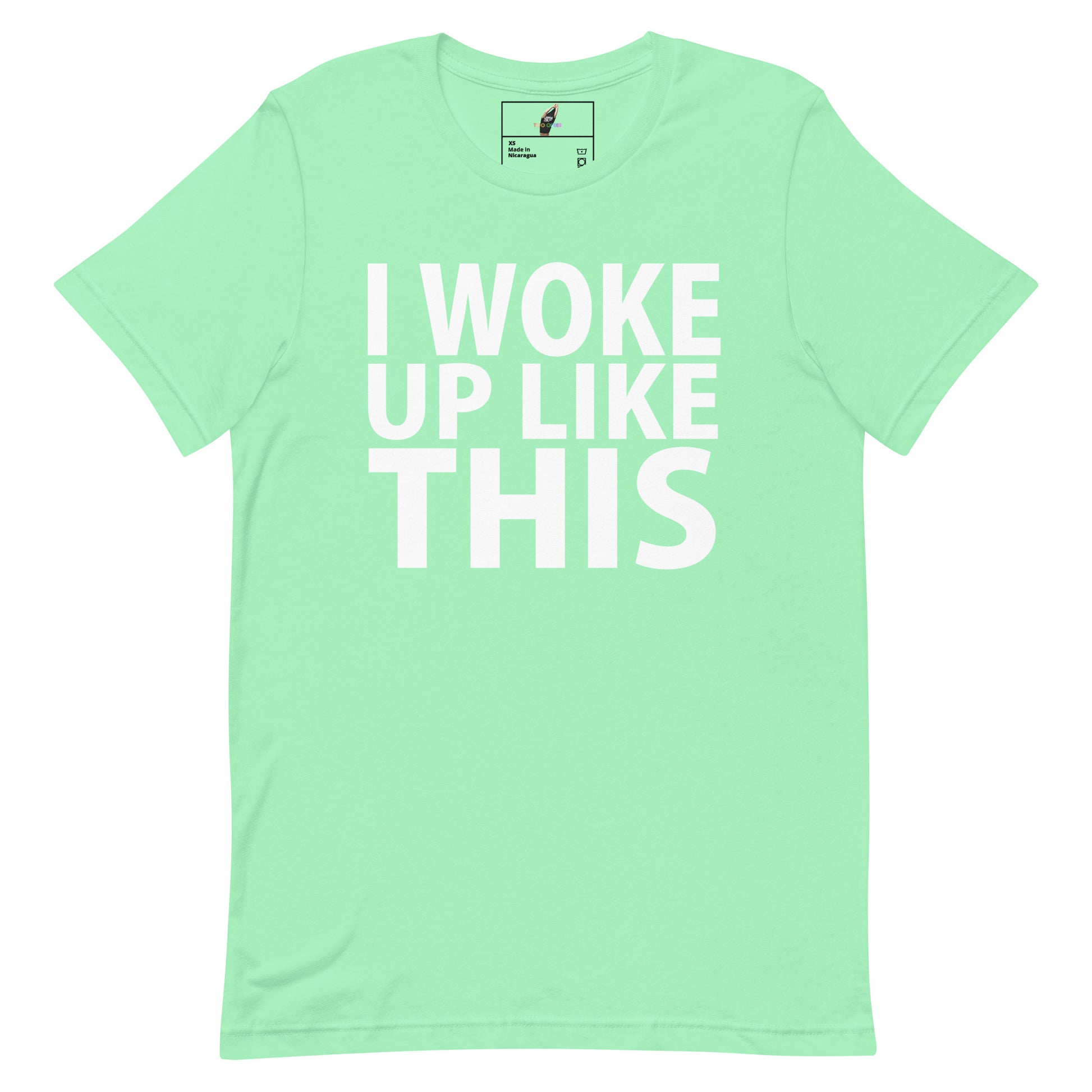 A mint green short-sleeve t-shirt with the phrase 'I WOKE UP LIKE THIS' printed in bold white capital letters across the front, displayed on a clean white background.