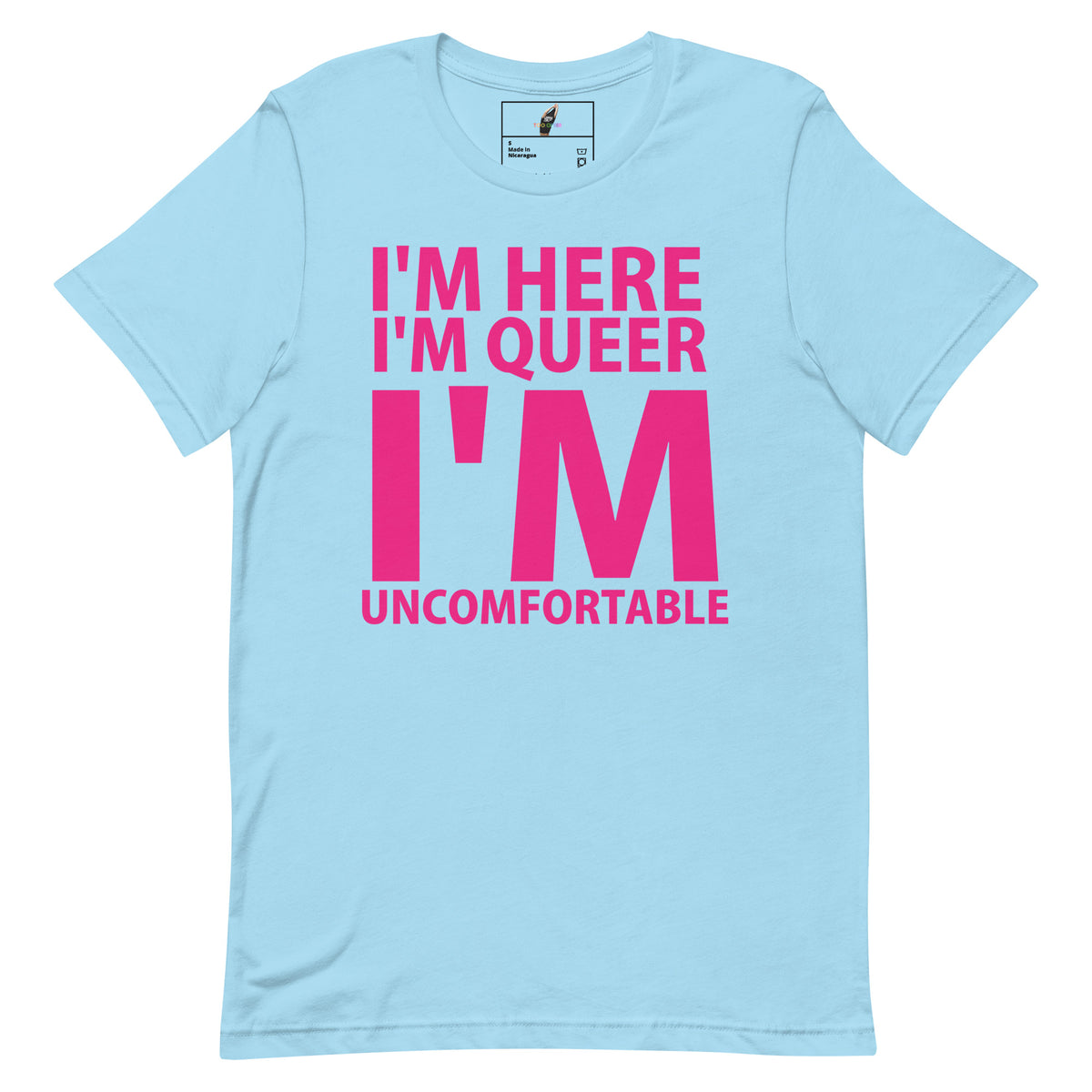 A light blue short-sleeve t-shirt with bold pink text on the front reading 'I'M HERE I'M QUEER I'M UNCOMFORTABLE'.