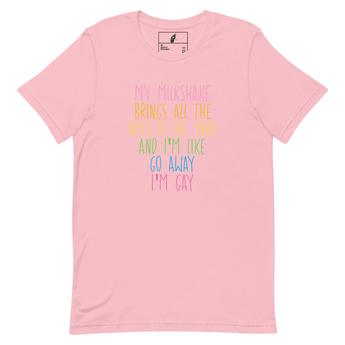 A light pink short-sleeve t-shirt with a colorful text graphic on the front reading 'MY MILKSHAKE BRINGS ALL THE BOYS TO THE YARD AND I'M LIKE GO AWAY I'M GAY' in pastel pink, yellow, green, and blue lettering. The shirt is displayed flat against a solid white background.