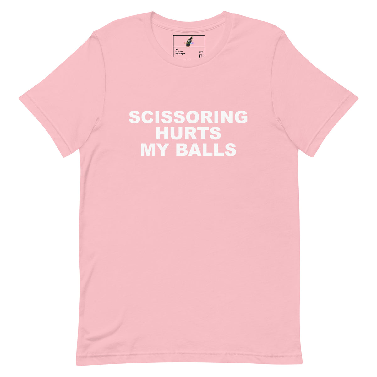 A light pink short-sleeve crewneck t-shirt with bold white text on the front reading 'SCISSORING HURTS MY BALLS'. The shirt is displayed flat against a clean white background, showing a small brand label inside the collar.