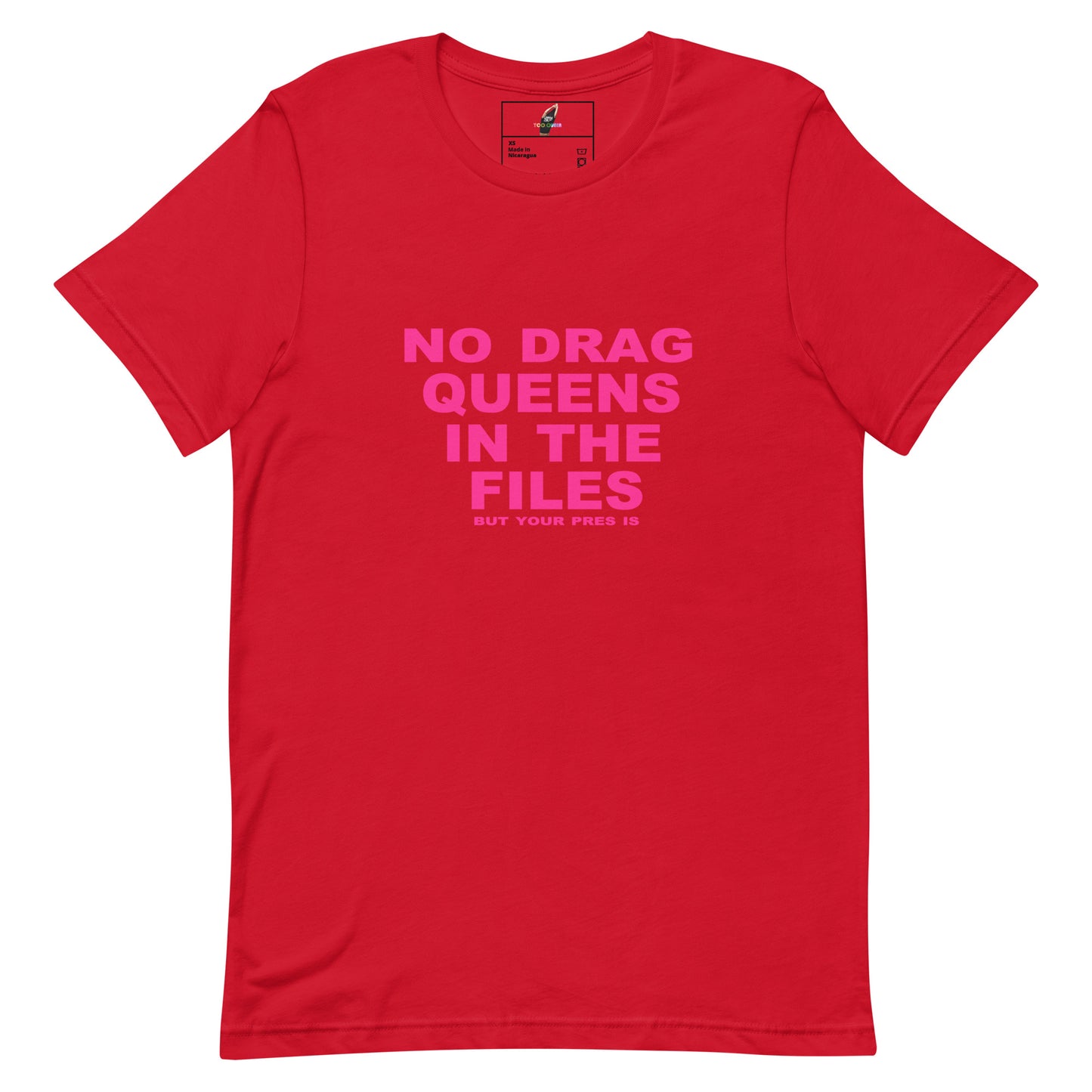 A red short-sleeve crewneck t-shirt with a bright pink text graphic on the front reading 'NO DRAG QUEENS IN THE FILES'.