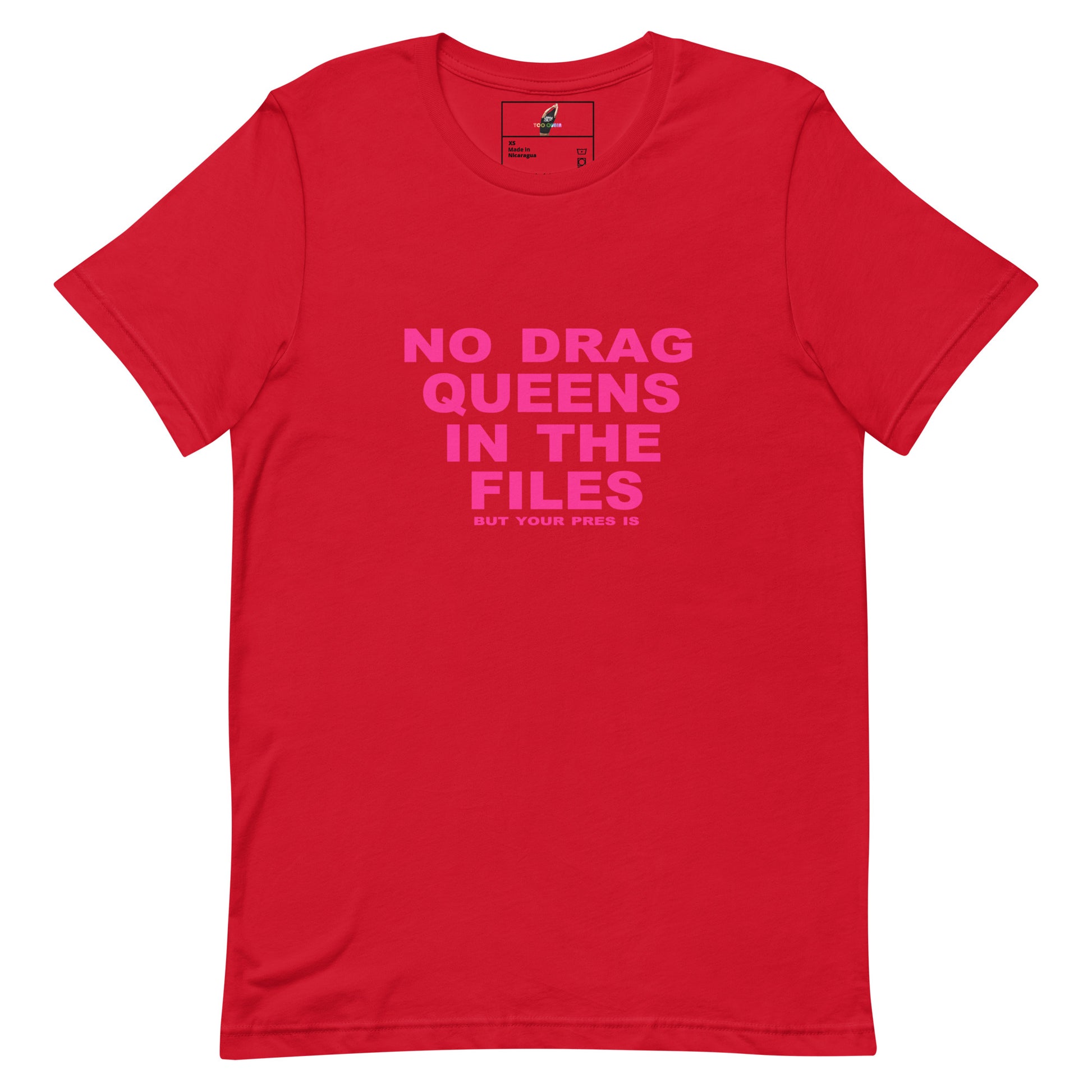 A red short-sleeve crewneck t-shirt with a bright pink text graphic on the front reading 'NO DRAG QUEENS IN THE FILES'.