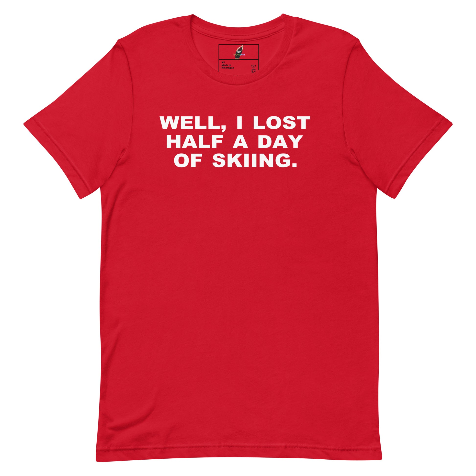 A red short-sleeve crewneck t-shirt with the phrase 'WELL, I LOST HALF A DAY OF SKIING.' printed in bold white capital letters across the chest, displayed flat against a solid white background.