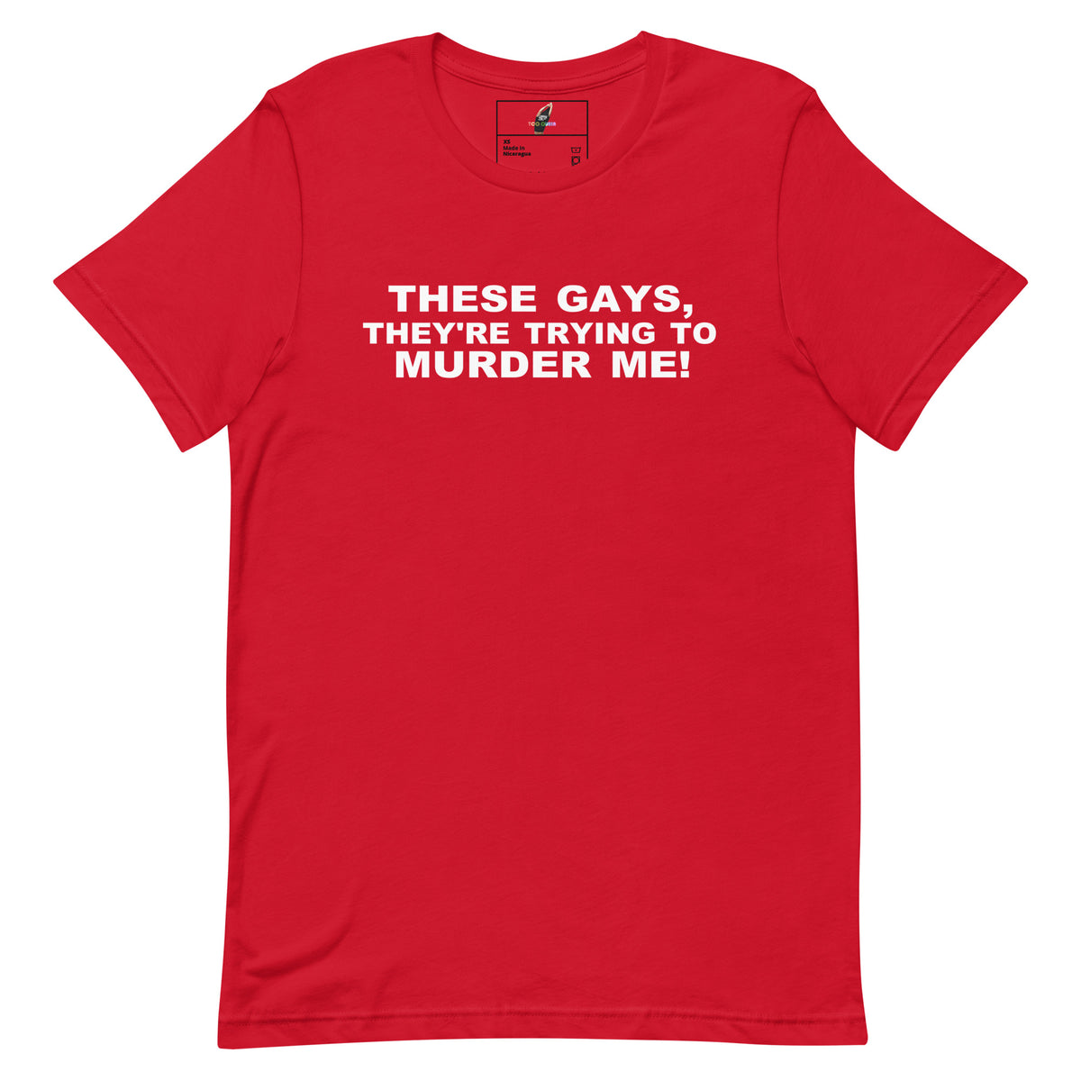 A red short-sleeve crewneck t-shirt with bold white text on the chest that reads 'THESE GAYS, THEY'RE TRYING TO MURDER ME!'. The shirt is presented flat against a solid white background.