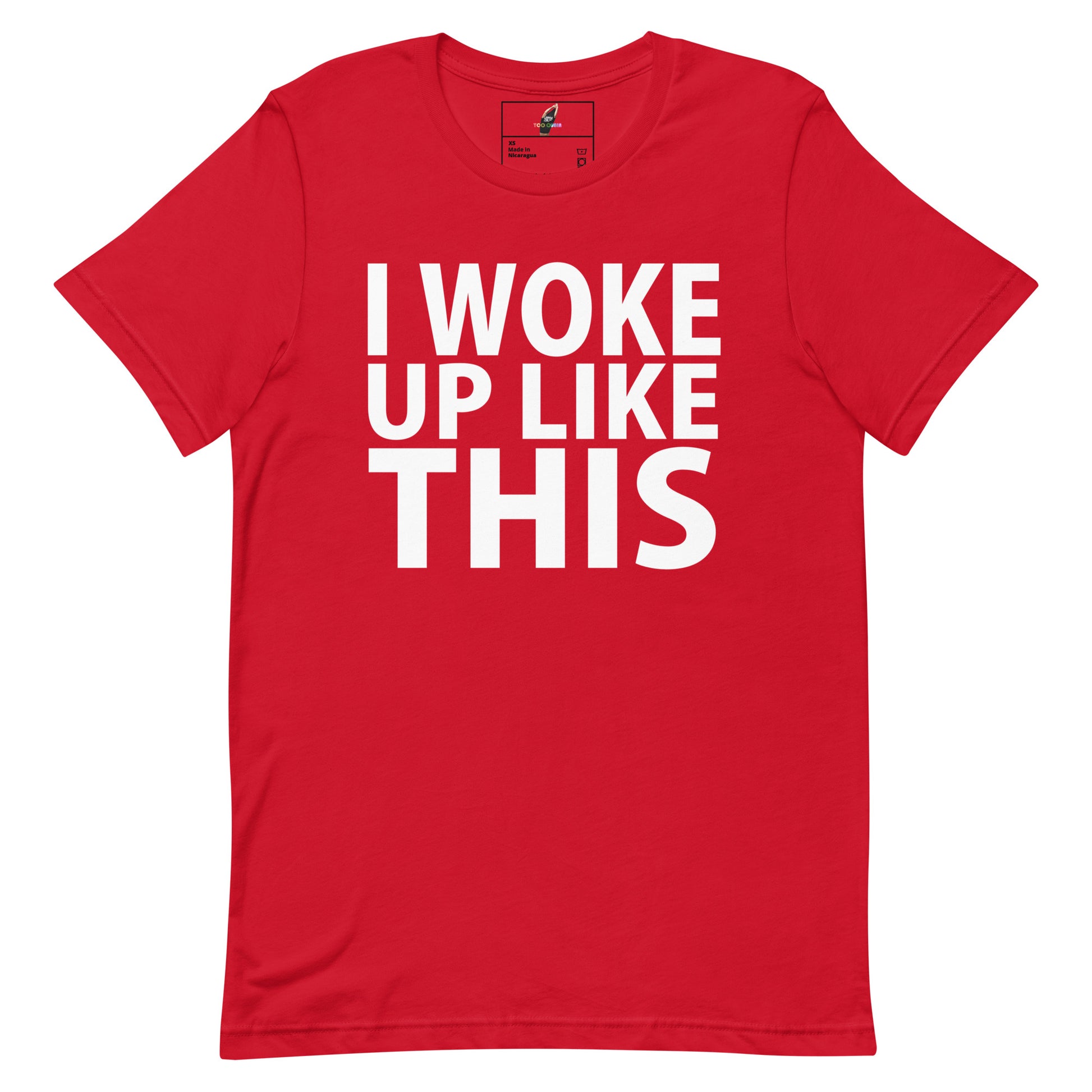 A red short-sleeve crewneck t-shirt with the phrase 'I WOKE UP LIKE THIS' printed in bold white capital letters across the chest, displayed flat against a plain white background.