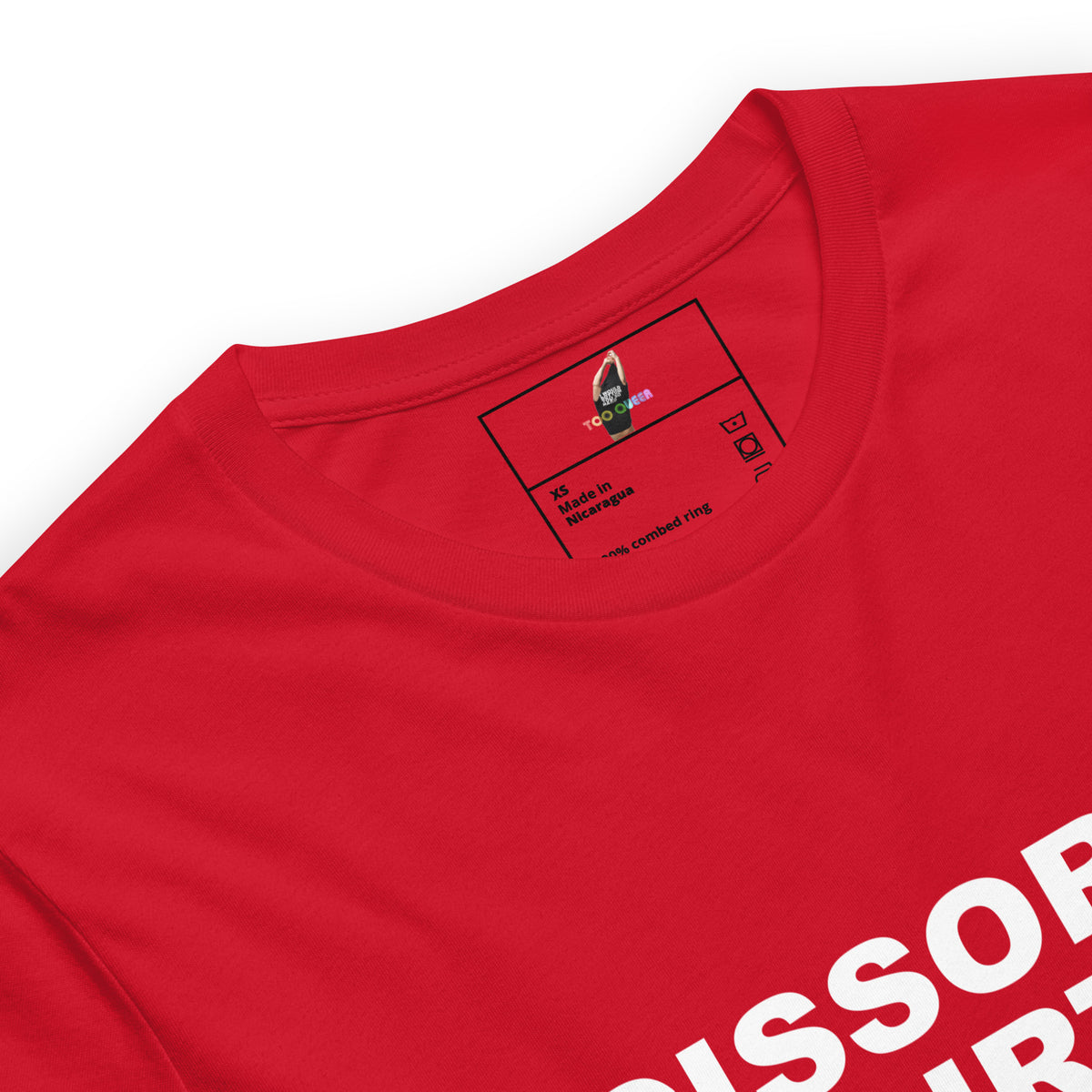 Close-up of a bright red short-sleeve t-shirt showing the inner neck label and part of a white graphic print on the lower right side, photographed on a clean white background.