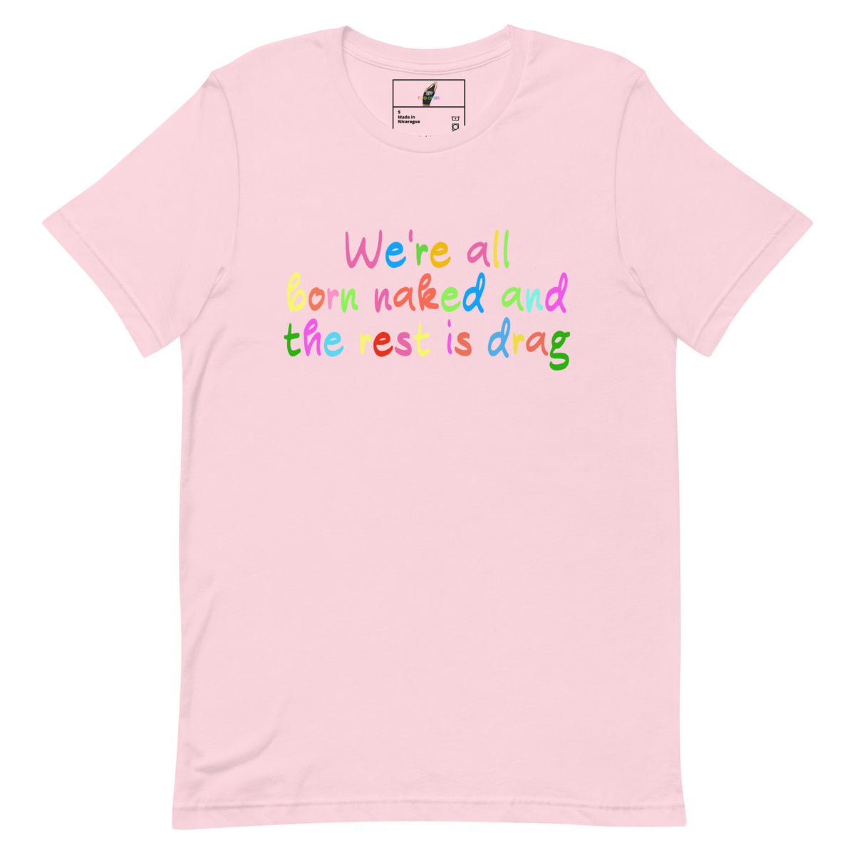 A light pink short-sleeve crewneck t-shirt featuring the phrase 'We're all born naked and the rest is drag' printed across the chest in a playful, multicolored rainbow font. The shirt is displayed flat against a clean white background, with a visible brand label inside the collar.