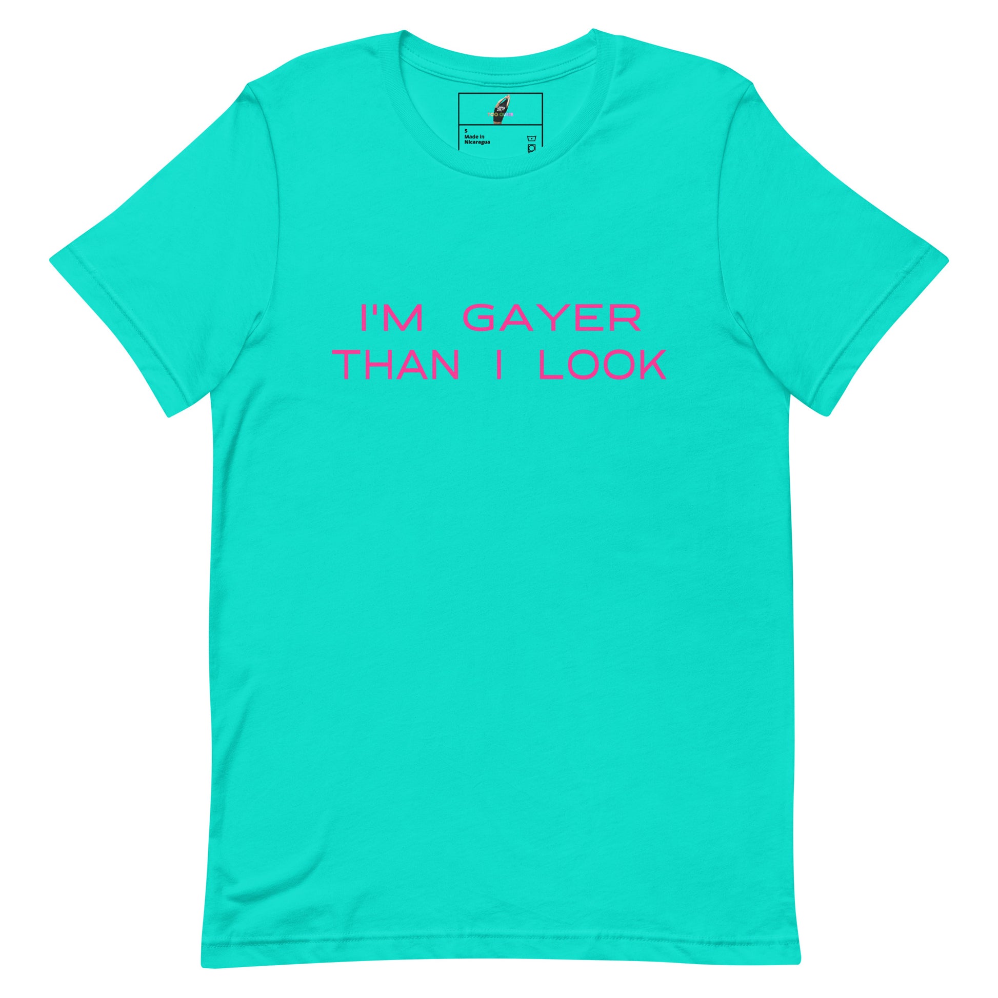 A bright turquoise short-sleeve crewneck t-shirt with the phrase 'I'M GAYER THAN I LOOK' printed in pink across the chest, displayed flat against a solid white background.