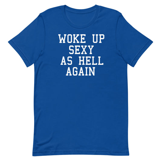 A royal blue short-sleeve crewneck t-shirt with the phrase 'WOKE UP SEXY AS HELL AGAIN' printed in white block letters across the chest, shown on a plain white background.
