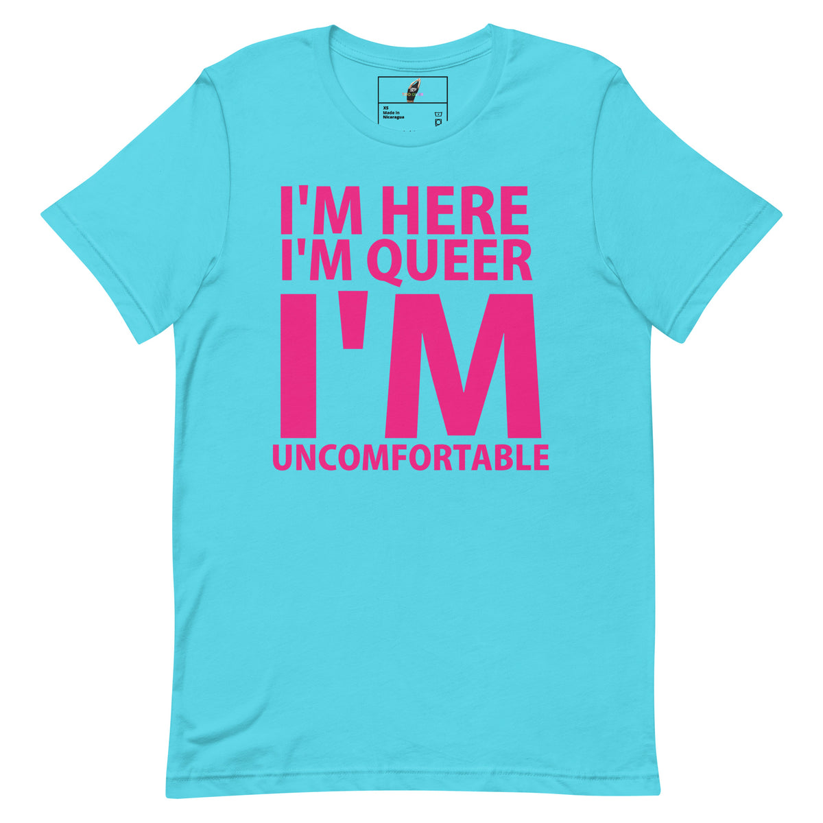 A light blue short-sleeve t-shirt with a bold pink graphic text on the front reading 'I'M HERE I'M QUEER I'M UNCOMFORTABLE'.