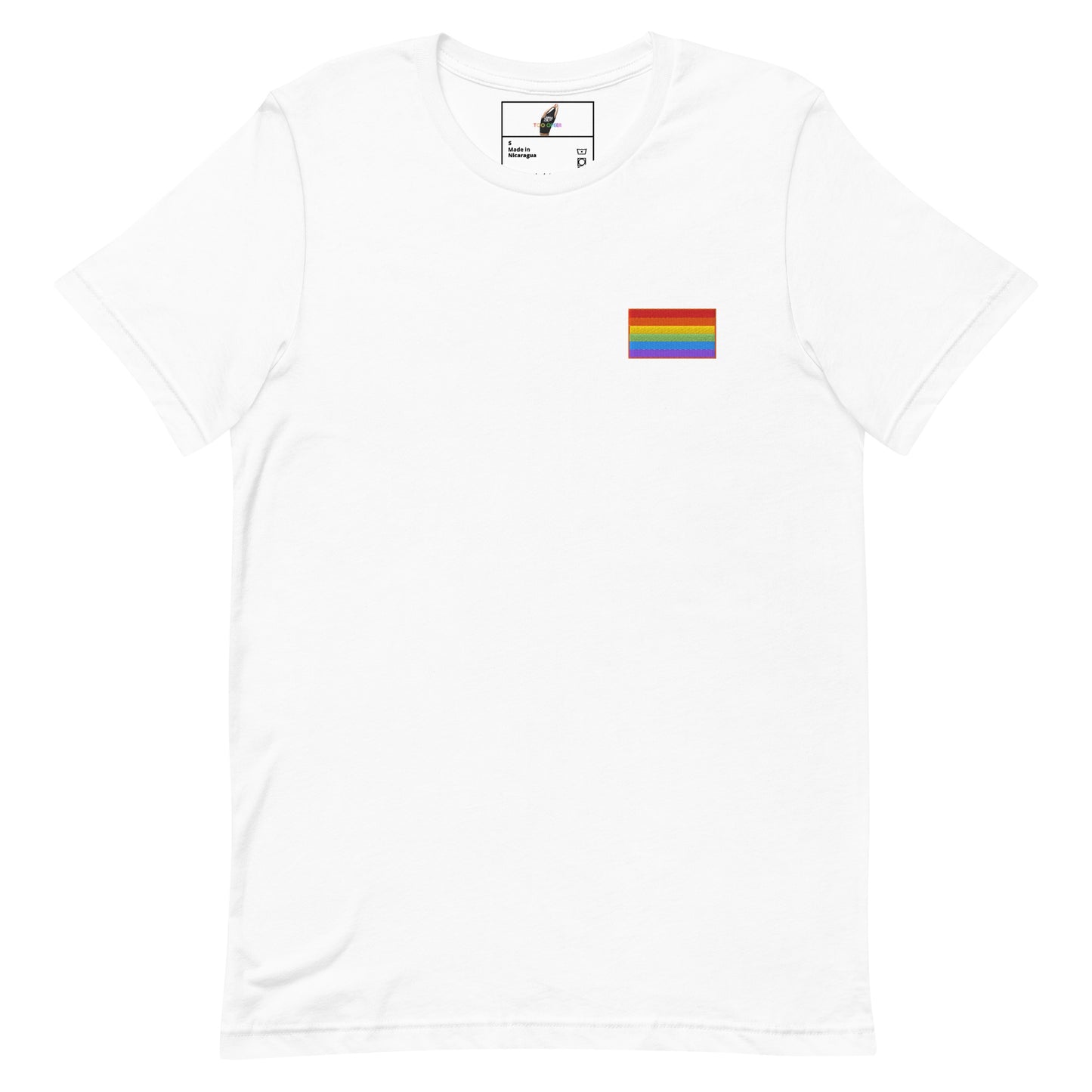A white short-sleeve crewneck t-shirt featuring a small Progress Pride flag graphic on the left chest, displayed against a solid white background.