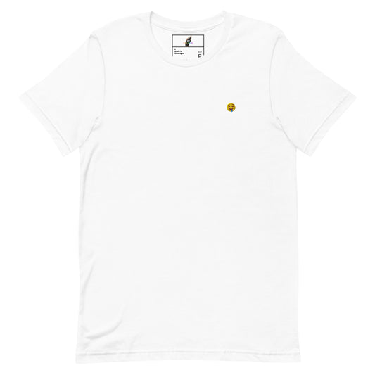 A white short-sleeve crewneck t-shirt with a small yellow smiley face graphic printed on the left chest, displayed flat against a white background.