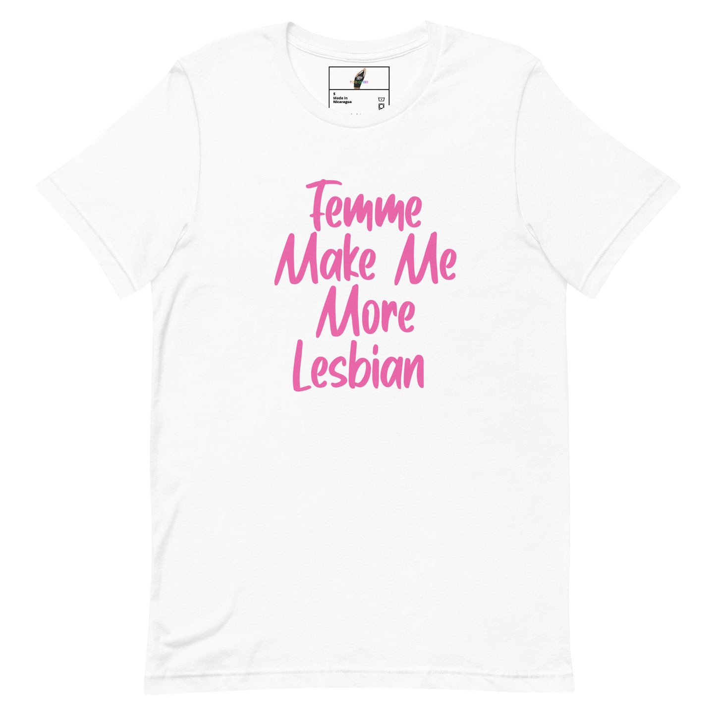 A white short-sleeve crewneck t-shirt featuring the phrase 'Femme Make Me More Lesbian' printed in pink script across the chest, displayed on a clean white background.