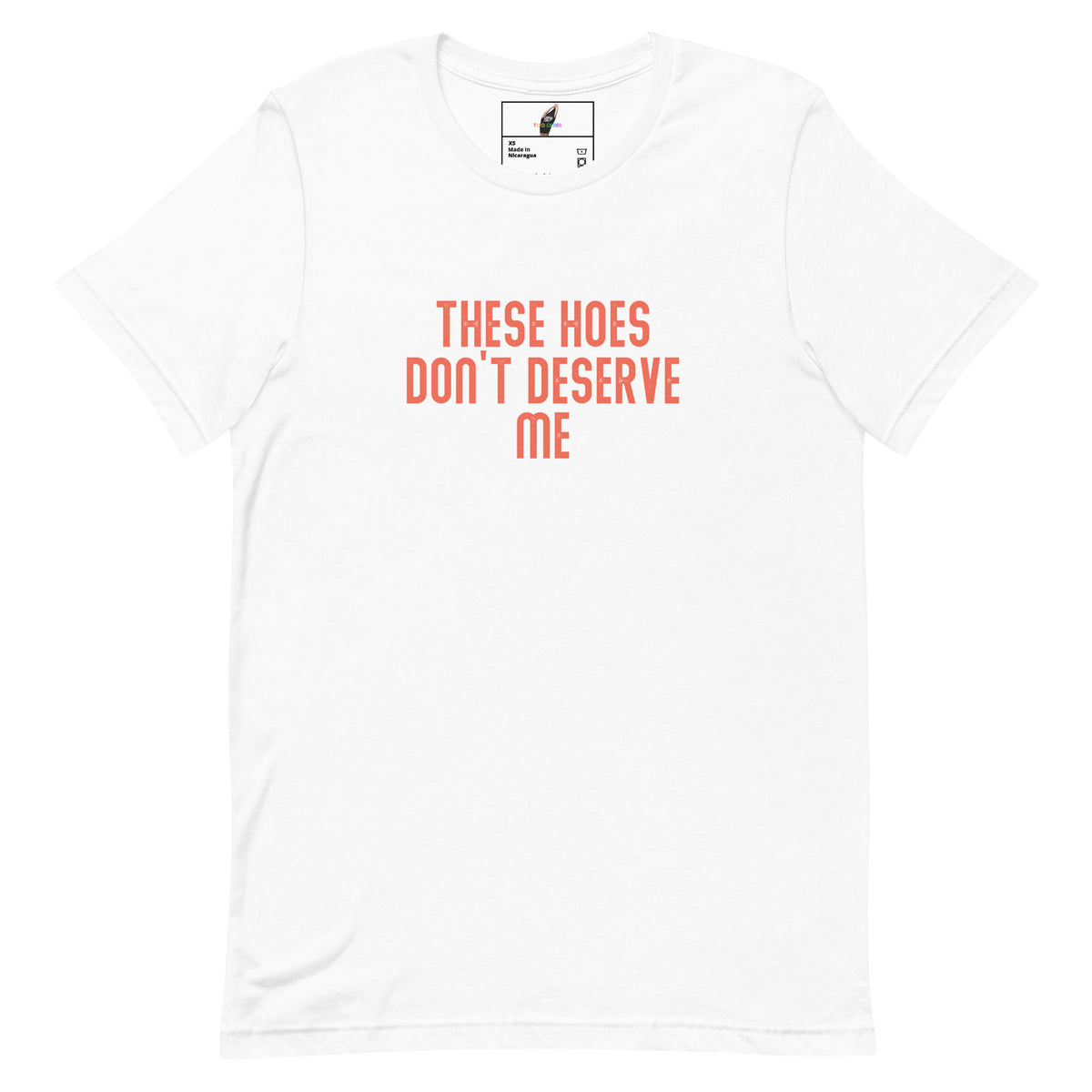 A white short-sleeve crewneck t-shirt with the text 'THESE HOES DON'T DESERVE ME' printed in a coral orange sans-serif font on the chest, displayed on a clean white background.