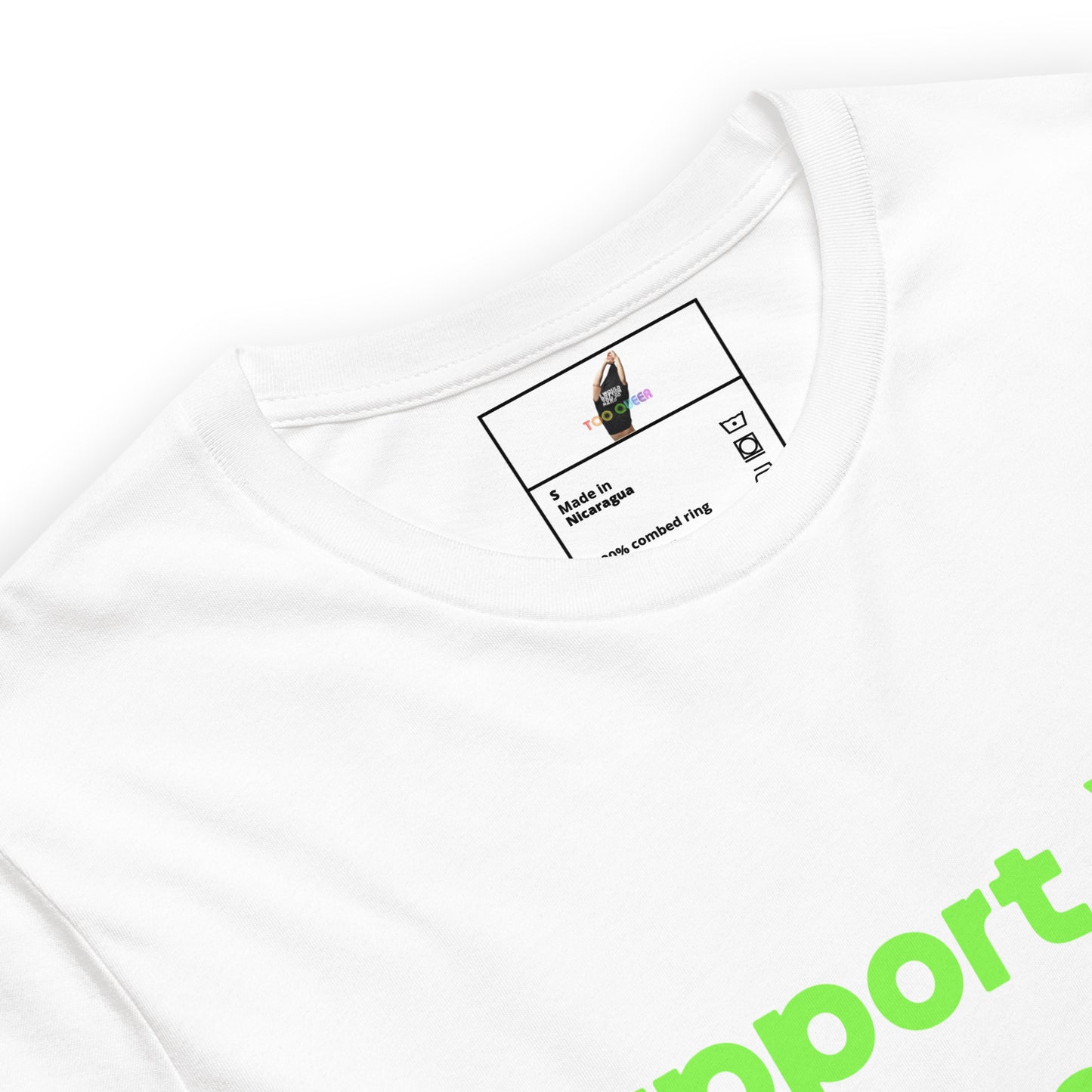 Close-up of a white crewneck t-shirt showing the inner neck label with a graphic of a hand in a black trapeze and the text 'made in INDONESIA' and 'from combined ring'. A bright green graphic text 'mport' is visible on the lower right.